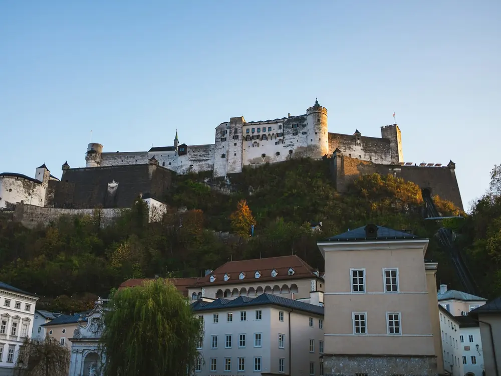 Hohensalzburg Fortress on its hill above the houses of Salzburg's old town in late-afternoon light